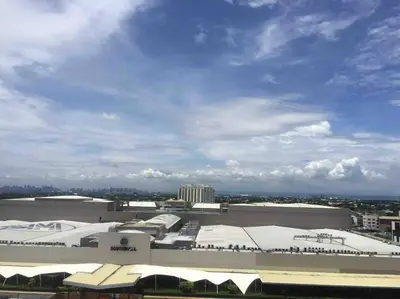 a large building with snow on the roofs at A Cozy 2 Bedroom Unit with a Parking at Tower 2 South Residences SM Southmall in Manila