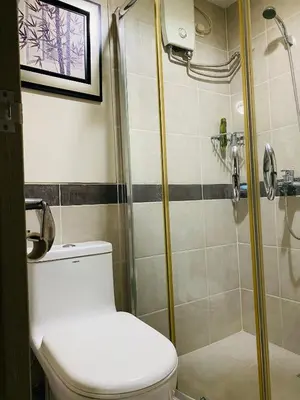 a bathroom with a toilet and a shower at FRD Condo Unit Tower A SoleMare Parksuites in Manila
