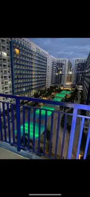 a view of a city from a balcony with buildings at Azenith Staycation At Sea Residences Moa in Manila