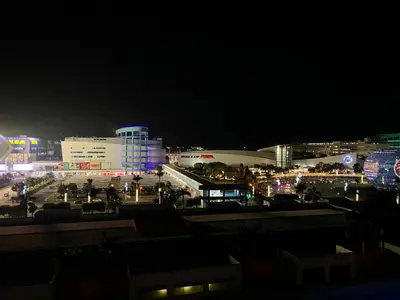 a view of a city at night with buildings at Azenith Staycation At Sea Residences Moa in Manila