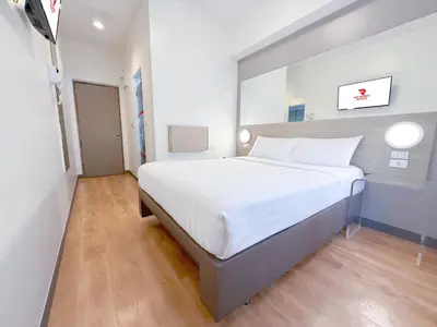 a bedroom with a large white bed in a room at Red Planet Ortigas in Manila