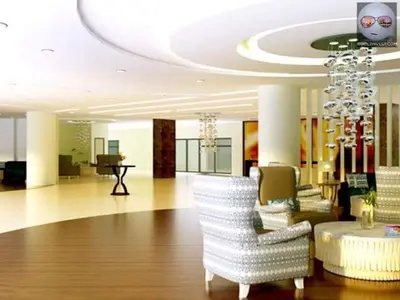 a lobby with white chairs and a chandelier at SHELL RESIDENCE C6 shortwalk MALL OF ASIA in Manila