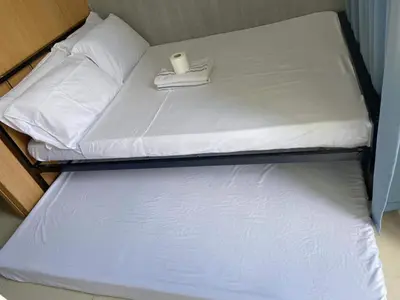 a small bed with a candle on top of it at SHELL RESIDENCE C6 shortwalk MALL OF ASIA in Manila