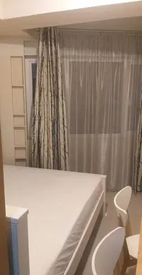 a bedroom with a bed and two chairs and a window at SHELL RESIDENCE c5, shortwalk MALL OF ASIA near Airport in Manila