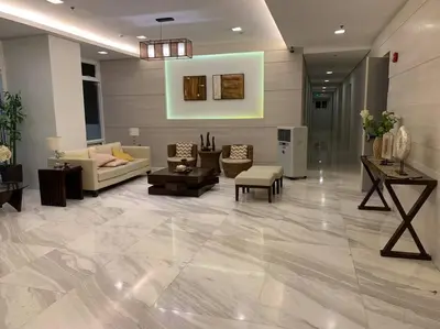 a lobby with couches and chairs and a table at At Home Condo With Free Pool Access in Manila