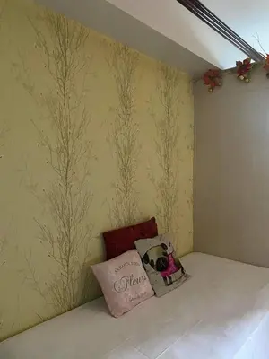 a bedroom with a wall with trees painted on it at Madison's Place at Sea MOA in Manila