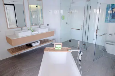 a bathroom with two sinks and a shower at Lime Resort Manila in Manila