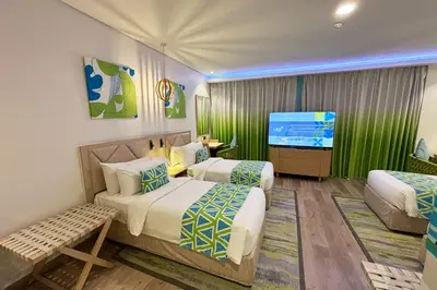 a hotel room with two beds and a flat screen tv at Lime Resort Manila in Manila