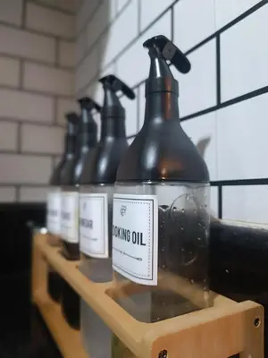 a row of bottles ofying oil sitting on a shelf at SMDC Coast Residences near PICC World Trade Center MOA in Manila