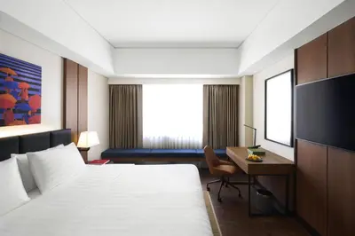 a hotel room with a bed and a desk at Seda Bonifacio Global City Manila in Manila