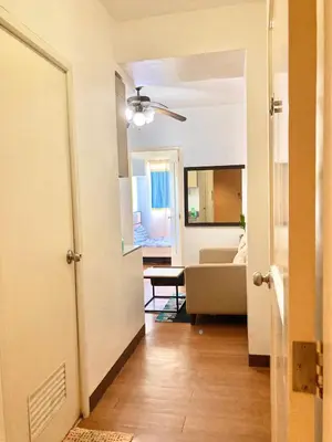 a hallway with a living room with a couch at Pacific Residences Condo Del Juana Near BGC Taguig in Manila