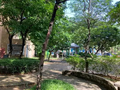 a park with a bench and trees and a street at Pacific Residences Condo Del Juana Near BGC Taguig in Manila