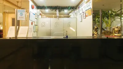 a display case in a museum with a white wall at Peace Hotel by RedDoorz in Manila