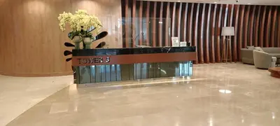 a lobby with a tower counter with flowers on it at Adel's Cosy Place - SMDC Shore 2 Philippines in Manila