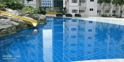 a swimming pool with a slide in a building at Adel's Cosy Place - SMDC Shore 2 Philippines in Manila