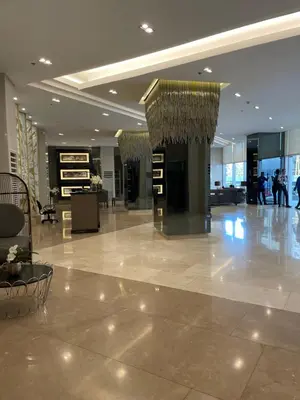 a lobby of a building with people walking in it at Condominium Fame Residence in Manila