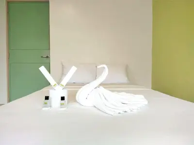 a bed with two swans sitting on top of it at Sulit Condo Unit Santa Mesa Manila in Manila