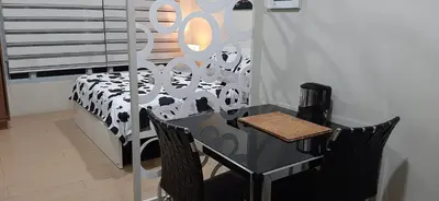 a black and white table and chairs in a room at Cozy City View Condo @ Newport NAIA T3 Airport & RWM in Manila
