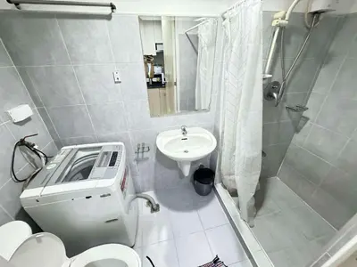 a bathroom with a sink and a toilet and a shower at Sea Residences by EXIN in Manila