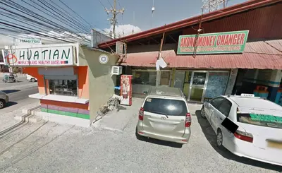 two cars parked in a parking lot in front of buildings at 2-Bedroom Condo in Imus Cavite with UNLI WIFI, 50