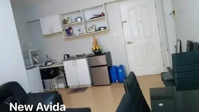 a living room with a kitchen and a refrigerator at New Avida JVB Homestyle in Manila