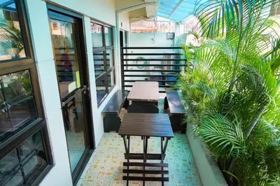 a balcony with benches and plants in a building at TARASA HOSTEL in Manila