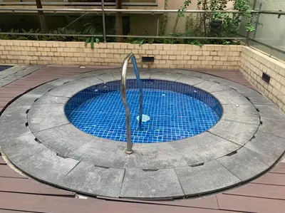 a swimming pool with a fountain in the middle at 150 Newport Boulevard Near NAIA Terminal 3 in Manila