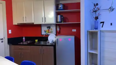 a kitchen with a sink and a refrigerator at Affordable Suite at 150 Newport Blvd near NAIA T3 in Manila
