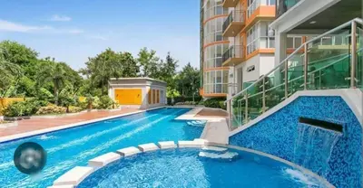 a swimming pool in front of a building at The Lancris Residences, 2 Bedrooms, 1 Bathroom, Living-room, Kitchen & Pool is Free in Manila