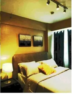 a bedroom with a bed and a lamp and two windows at The Lancris Residences, 2 Bedrooms, 1 Bathroom, Living-room, Kitchen & Pool is Free in Manila