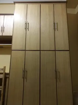 a group of wooden cabinets in a room at R'Holistay Vista Heights Legarda near CEU San Beda in Manila