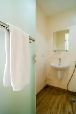 a bathroom with a sink and white towels at MySpace Hotel Comembo Taguig in Manila