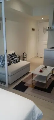 a living room with a bed and a coffee table at JN Condotel The Azure Urban Resort Residences in Manila