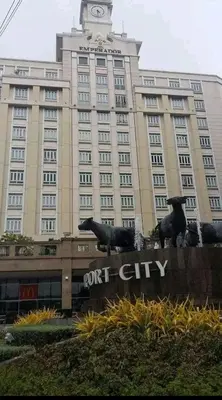 a large building with a clock tower on top of it at Pasay staycation @150Newport in Manila