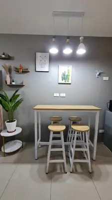 a table and two stools in a room at Chic Nordic Condo Unit at Shore Residences Mall of Asia in Manila