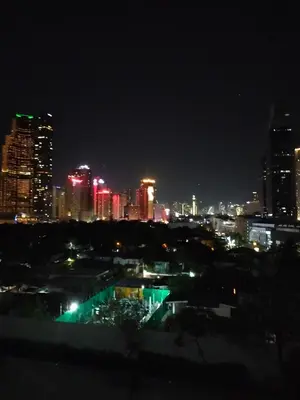 a city skyline at night with red and green lights at Gabriel's Den @ JazzB1109 in Manila