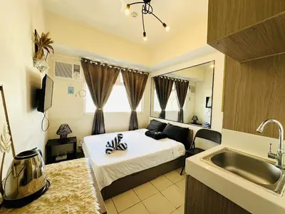 a bedroom with a bed and a sink in a room at Great View@Fully Equipped Condo w/ WiFi NETFLIX @the Metro in Manila
