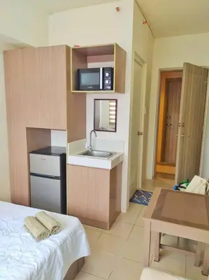 a small kitchen with a sink and a microwave at Great View@Fully Equipped Condo w/ WiFi NETFLIX @the Metro in Manila