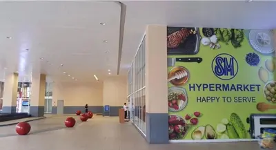 a large hallway with a sign in a building with fruits and vegetables at SMDC Jazz Residences in Manila