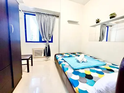 a bedroom with a bed with a stuffed animal on it at Sea Residences - Tino Val in Manila