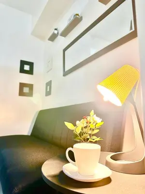 a table with a coffee cup and a lamp at Sea Residences - Val Alano in Manila