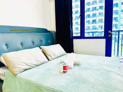 a bed with a cup of coffee sitting on it at Sea Residences - Val Alano in Manila