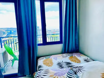 a bedroom with a bed in front of a window at Sea Residences - Val Alano in Manila