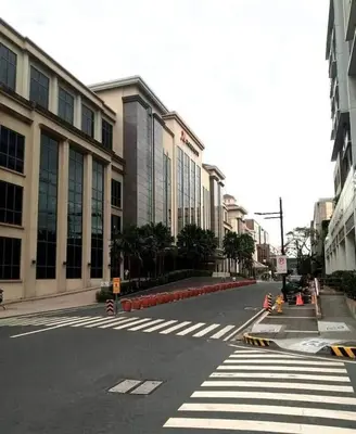 an empty street in a city with a building at Budget Apartment Manila across Manila Airport T3 in Manila