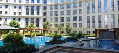 a large building with a swimming pool in front of a building at Budget Apartment Manila across Manila Airport T3 in Manila