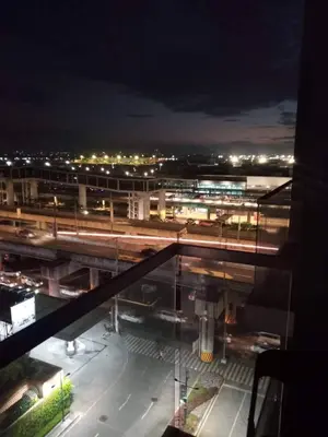 a view of a city at night from a building at Budget Apartment Manila across Manila Airport T3 in Manila