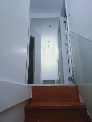 a stairway with a large glass door and a mirror at 2 Bedrooms Units Forbes Area 5th Avenue BGC Center in Manila