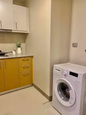 a laundry room with a washing machine in it at Uptown Parksuites in Manila