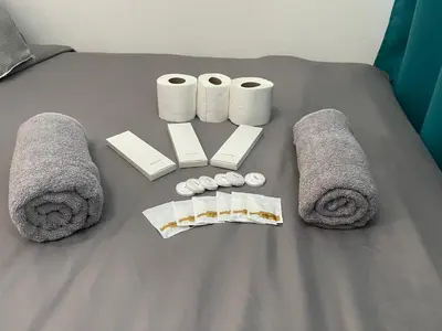 a table with towels and rolls of toilet paper at Grace Residences 1 Bedroom With Balcony Bgc View Netflix in Manila