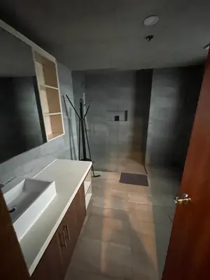 a bathroom with a sink and a counter top at 2 Bedroom Service Apartment In Quezon City in Manila